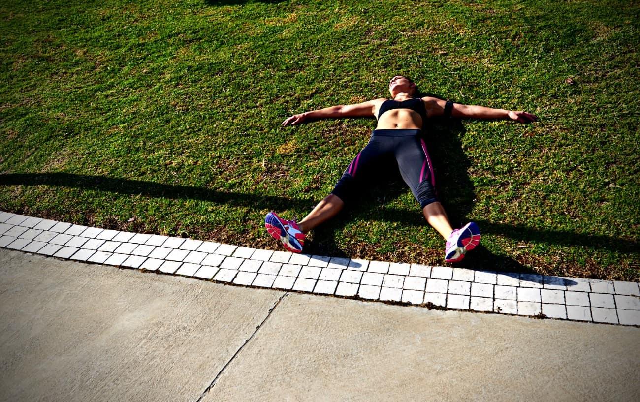 An exhausted runner lying on the ground.